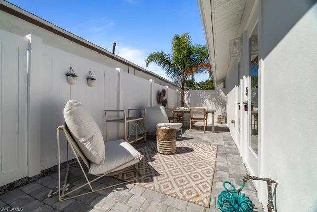 a view of a chairs and table in backyard of the house