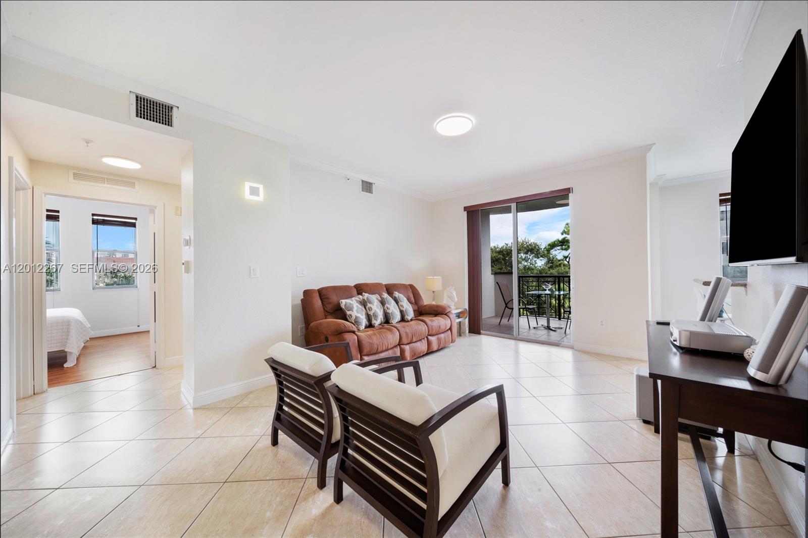 9021 Southwest 94th Street, Unit 310 Miami, FL 33176 - Photo 10 of 41 a living room with furniture and a flat screen tv
