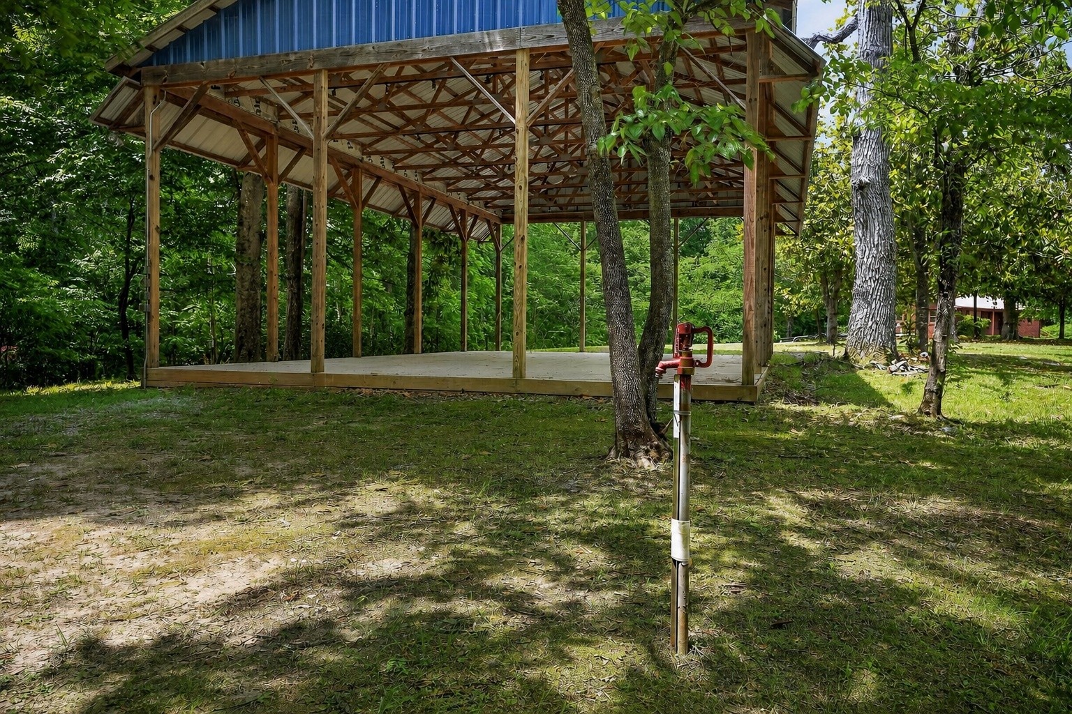5682 Pates Ford Road Smithville, TN 37166 - Photo 10 of 12 a backyard of a house with lots of green space and fountain