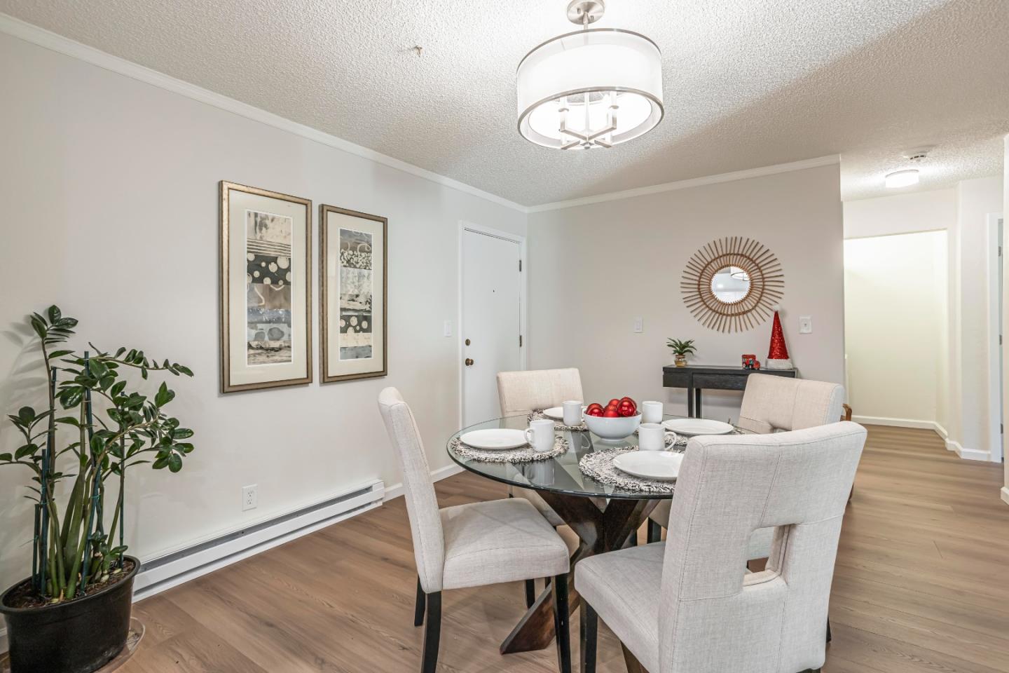 1033 Crestview Drive, Unit 309 Mountain View, CA 94040 - Photo 11 of 50 a dining room with wooden floor a chandelier a wooden table and chairs