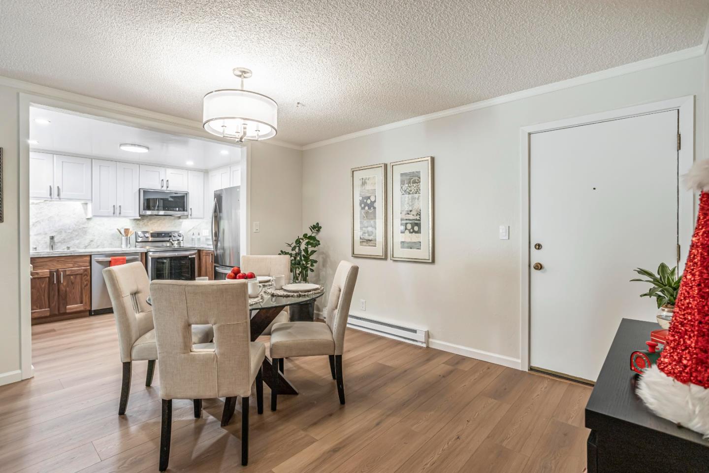 1033 Crestview Drive, Unit 309 Mountain View, CA 94040 - Photo 12 of 50 a view of a dining room with furniture wooden floor and a chandelier