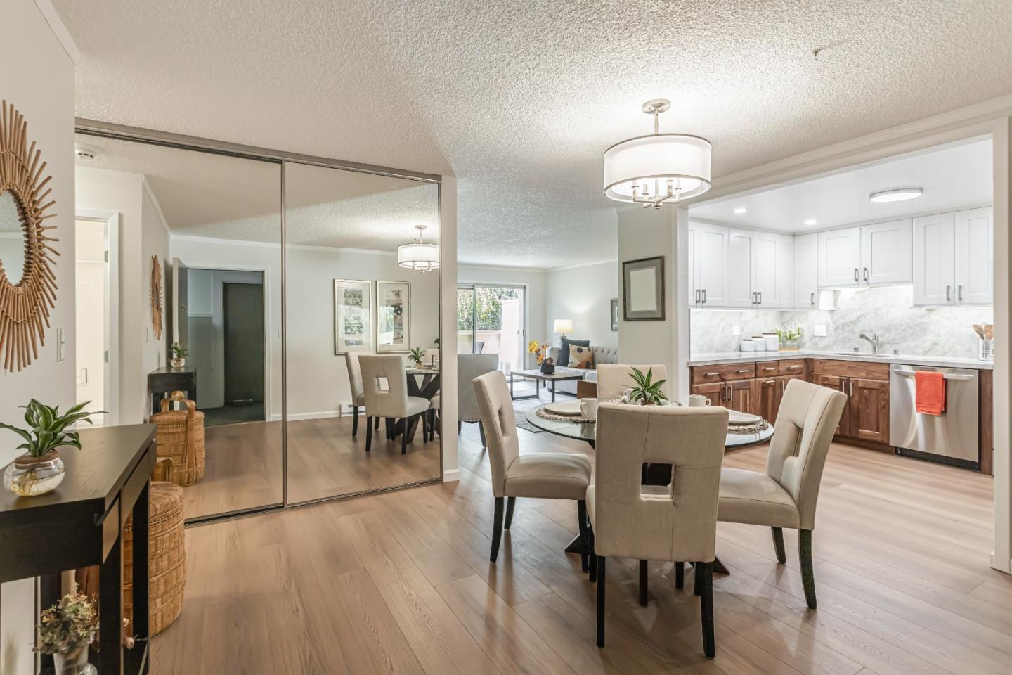 1033 Crestview Drive, Unit 309 Mountain View, CA 94040 - Photo 13 of 50 a dining room with wooden floor a chandelier a wooden table and chairs