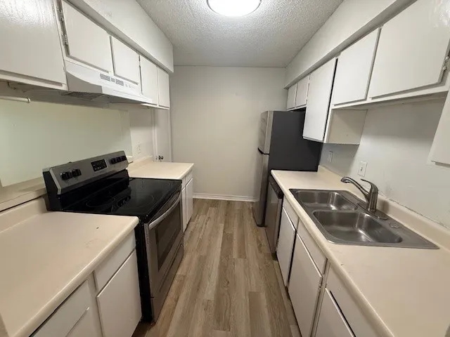 a kitchen that has a sink and a stove