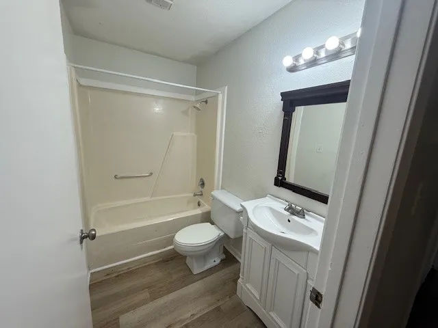 a bathroom with a toilet a sink and a mirror