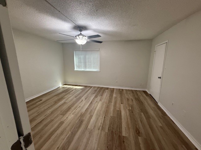 4217 I-69 Access Road, Unit 2 Corpus Christi, TX 78410 - Photo 6 of 14 wooden floor in an empty room with a window