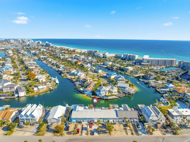 an aerial view of a city with lots of residential buildings lake and ocean view