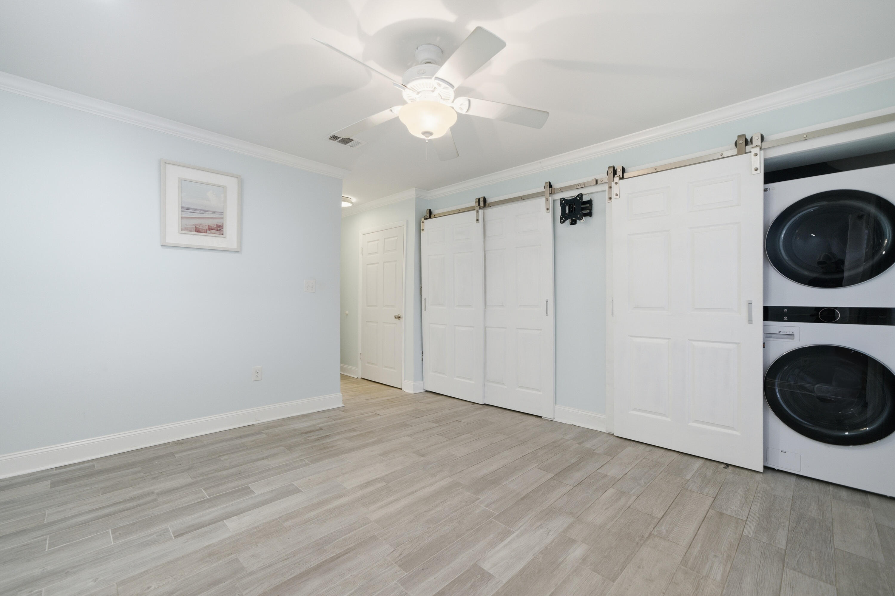 125 Durango Road Destin, FL 32541 - Photo 21 of 63 a view of a hallway with wooden floor and a ceiling fan