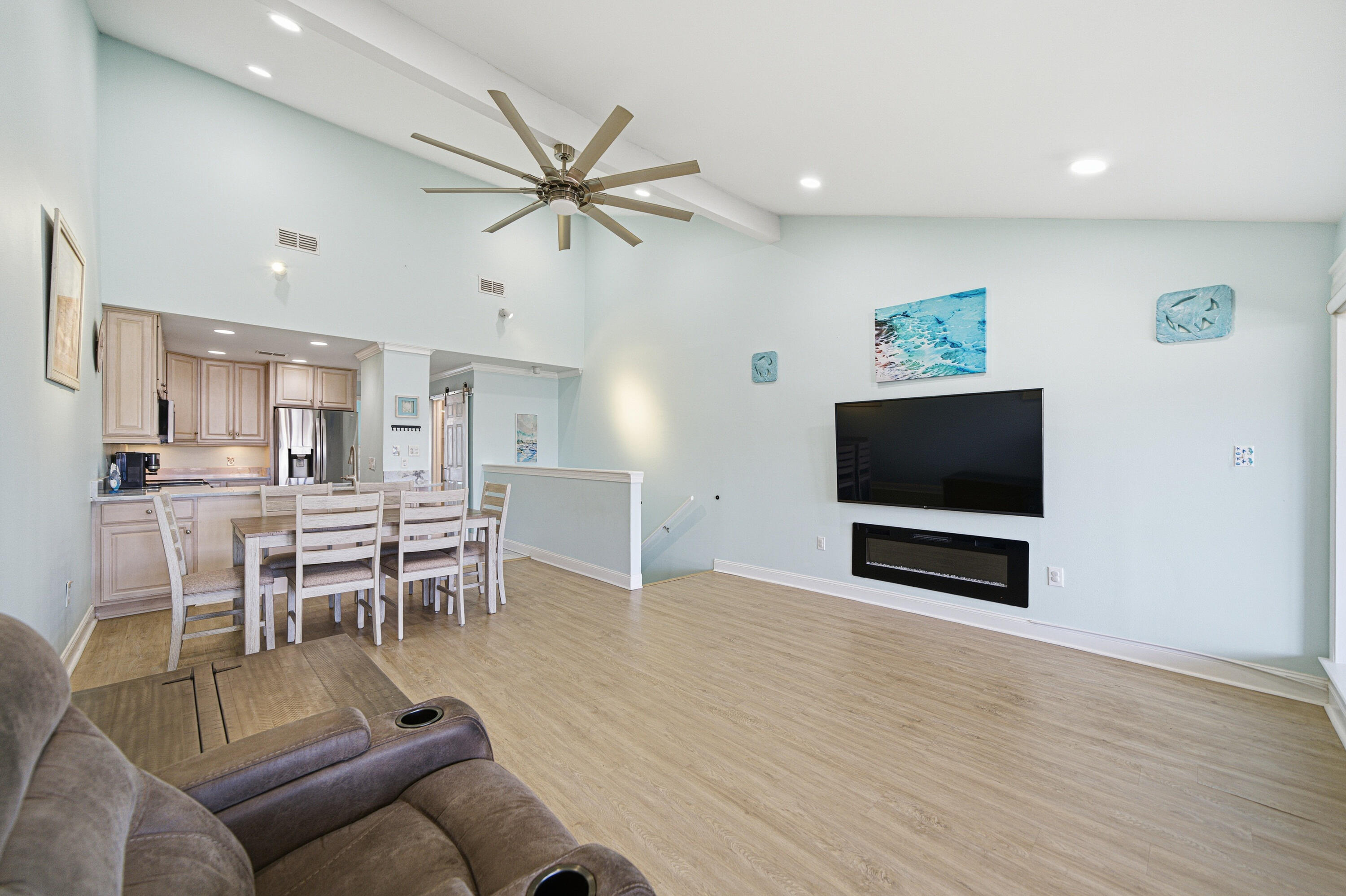 125 Durango Road Destin, FL 32541 - Photo 34 of 63 a living room with furniture a flat screen tv and kitchen view