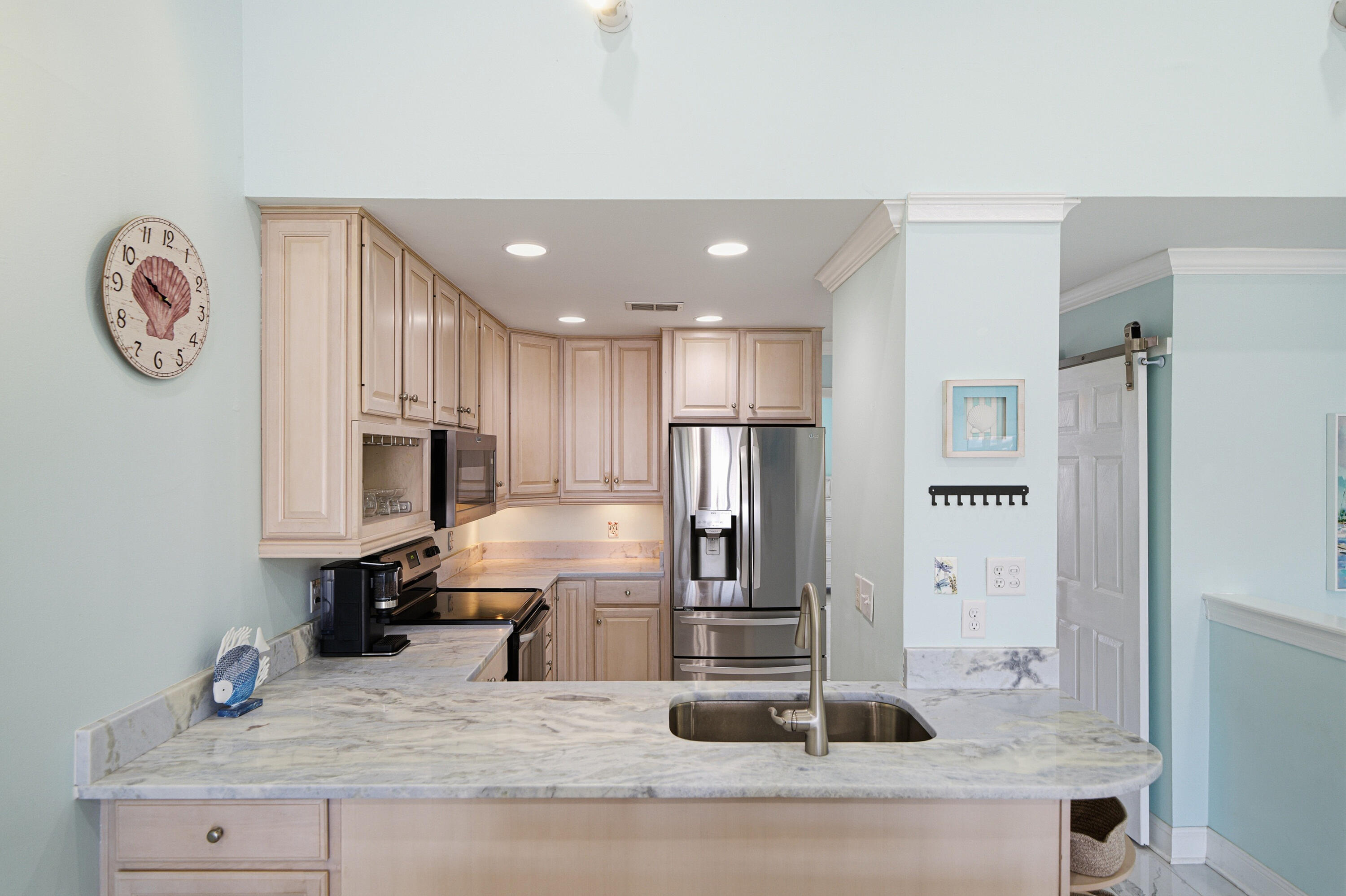 125 Durango Road Destin, FL 32541 - Photo 40 of 63 a kitchen with kitchen island a counter top space cabinets and stainless steel appliances
