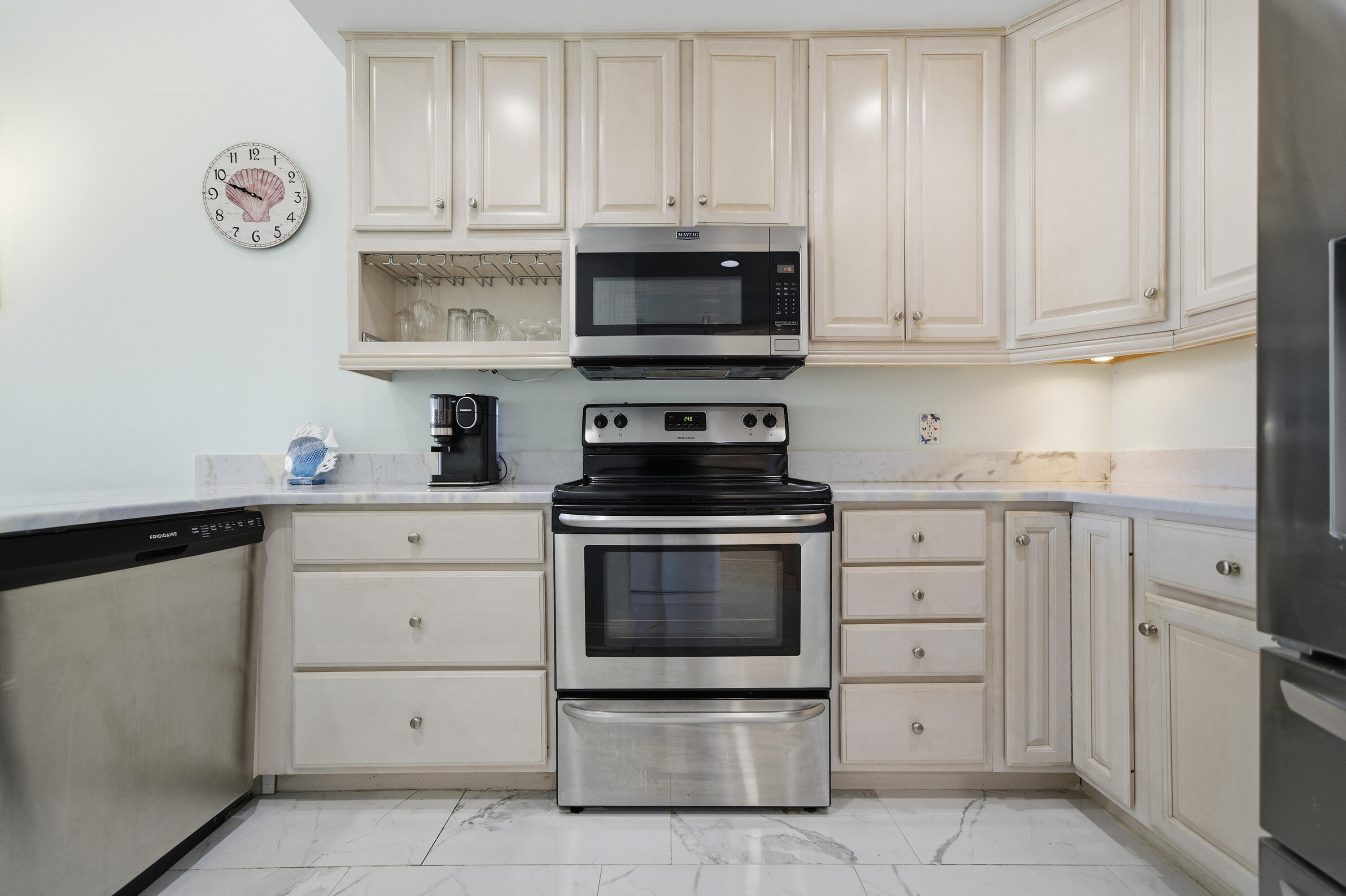 125 Durango Road Destin, FL 32541 - Photo 41 of 63 a kitchen with white cabinets and stainless steel appliances