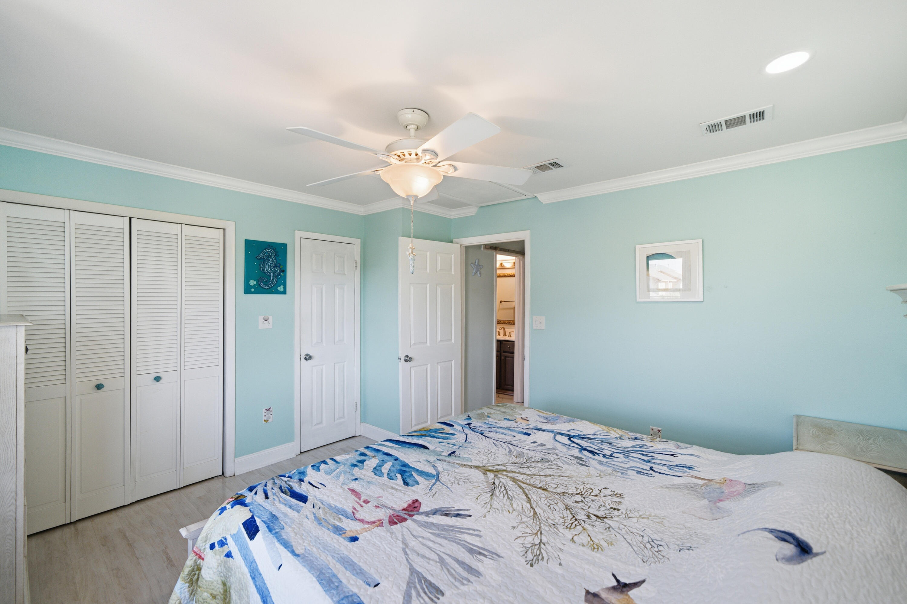 125 Durango Road Destin, FL 32541 - Photo 51 of 63 a bedroom with a bed and a chandelier