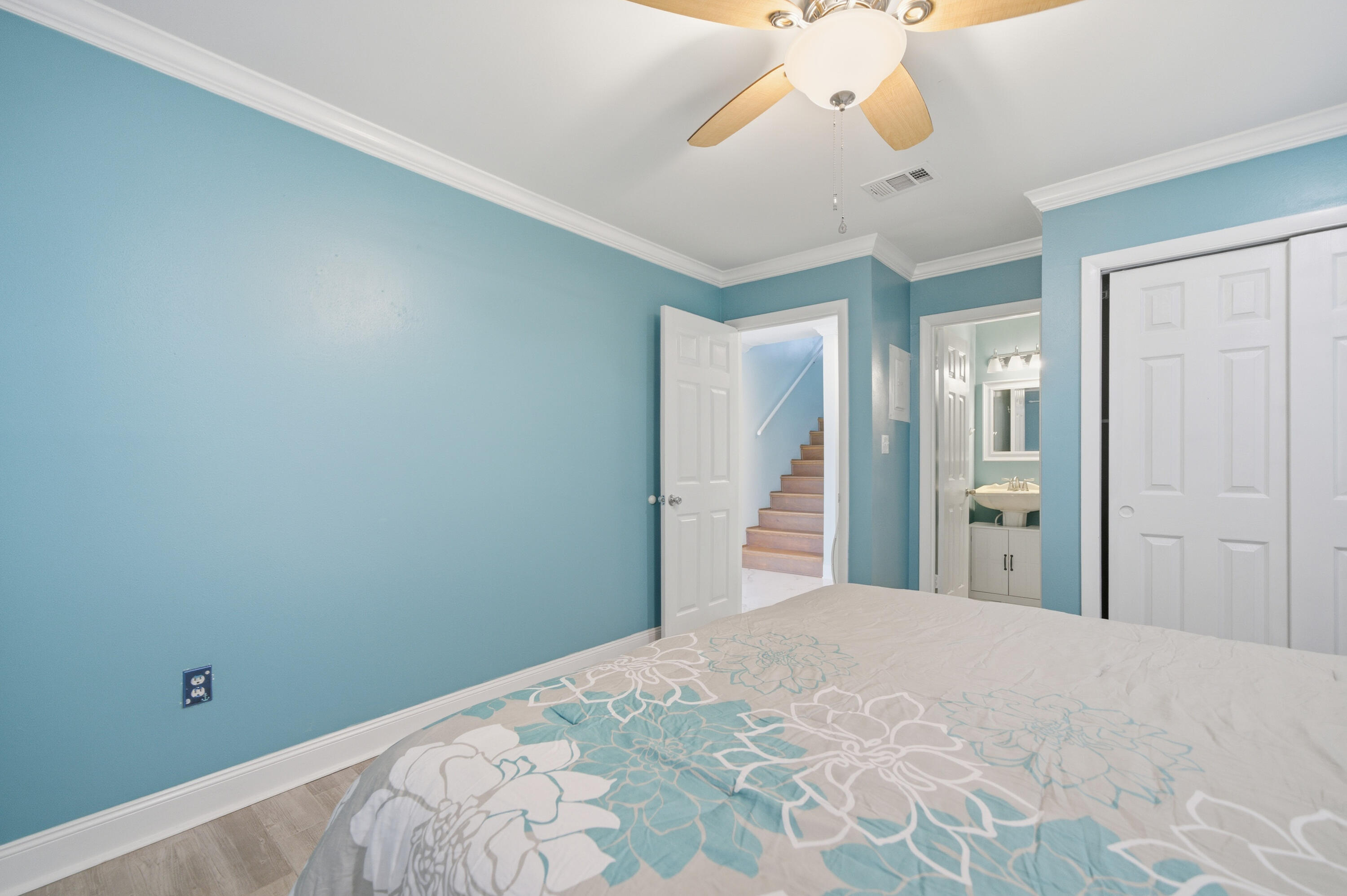 125 Durango Road Destin, FL 32541 - Photo 10 of 63 a bedroom with a bed and a chandelier