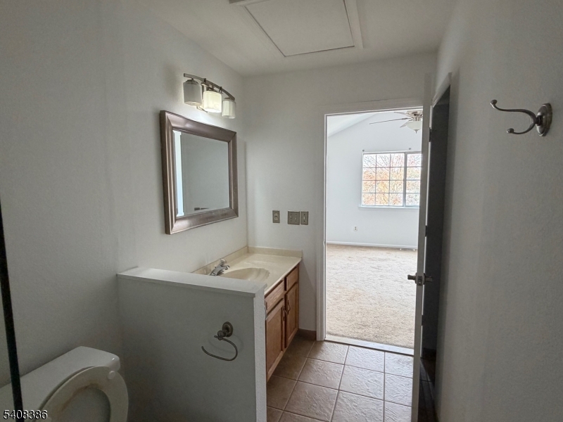 94 Wescott Road Bedminster, NJ 07921 - Photo 12 of 18 a bathroom with a toilet sink and mirror