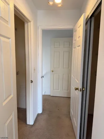 a view of a white house with a yard