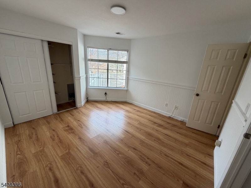 94 Wescott Road Bedminster, NJ 07921 - Photo 5 of 18 a view of an empty room with wooden floor and a window