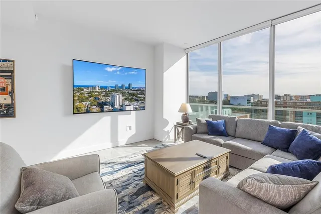 a living room with furniture and a large window