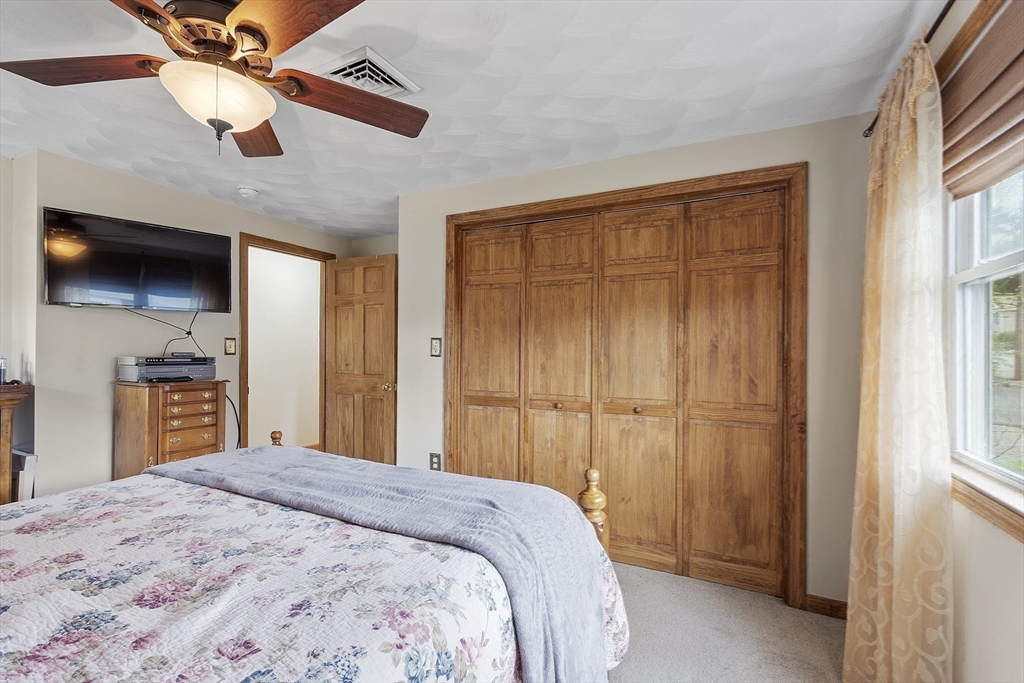 5 Elizabeth Road Billerica, MA 01821 - Photo 17 of 41 a bedroom with a bed and a chandelier