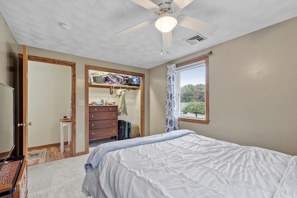 5 Elizabeth Road Billerica, MA 01821 - Photo 19 of 41 a bedroom with a large bed and a chandelier