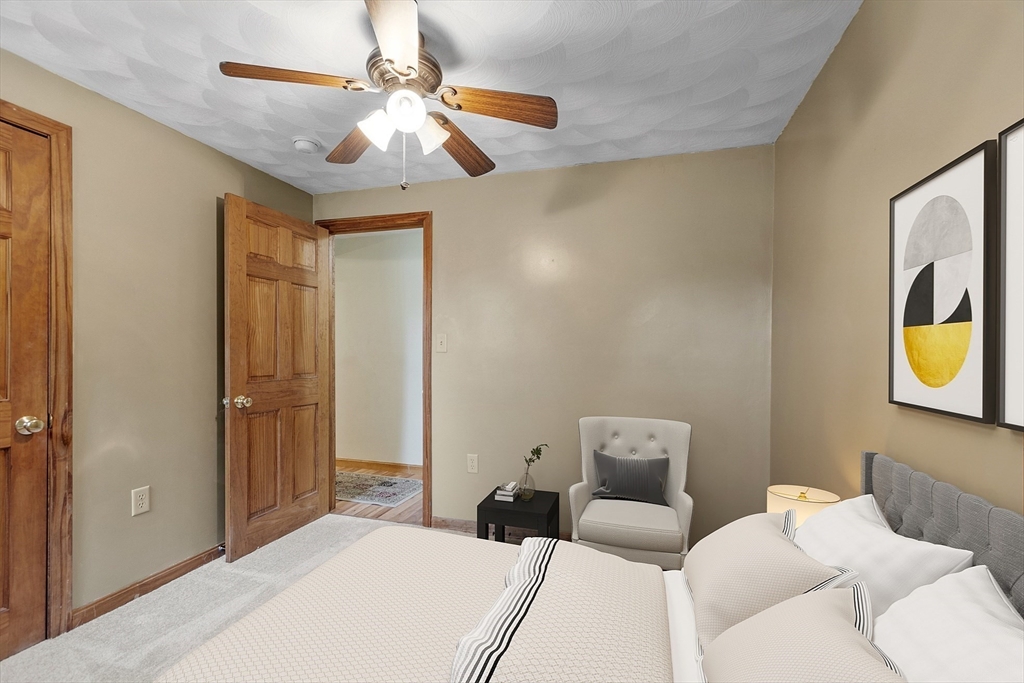 5 Elizabeth Road Billerica, MA 01821 - Photo 22 of 41 a bedroom with a bed and a chandelier