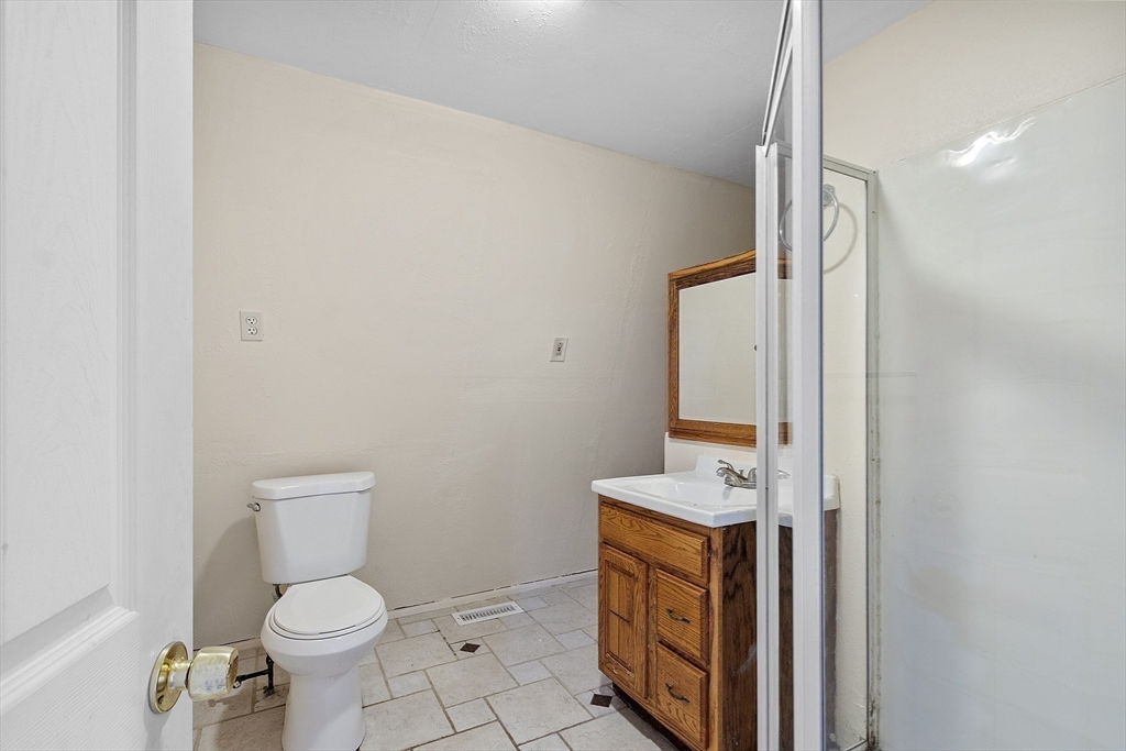 5 Elizabeth Road Billerica, MA 01821 - Photo 31 of 41 a bathroom with a toilet a sink and a mirror