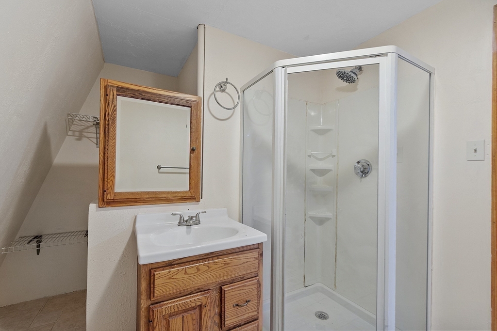 5 Elizabeth Road Billerica, MA 01821 - Photo 32 of 41 a bathroom with a shower a mirror and a sink
