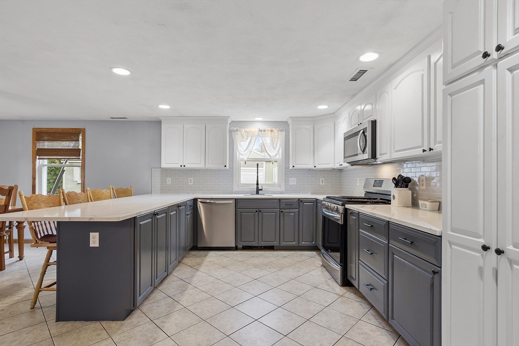 5 Elizabeth Road Billerica, MA 01821 - Photo 8 of 41 a kitchen with sink cabinets and window