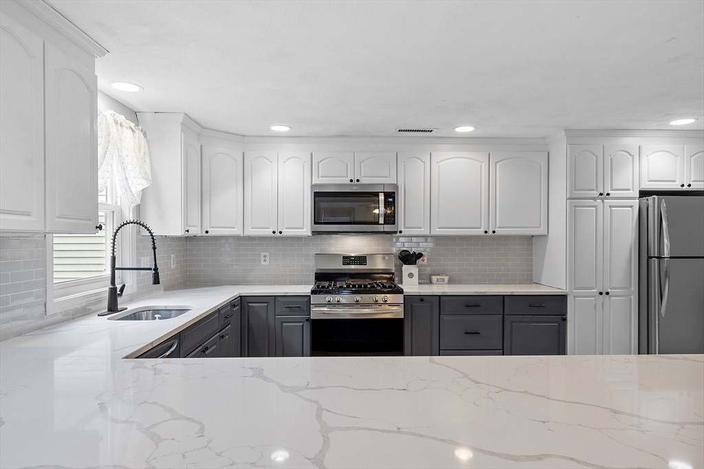 5 Elizabeth Road Billerica, MA 01821 - Photo 9 of 41 a kitchen with a sink a stove top oven and refrigerator