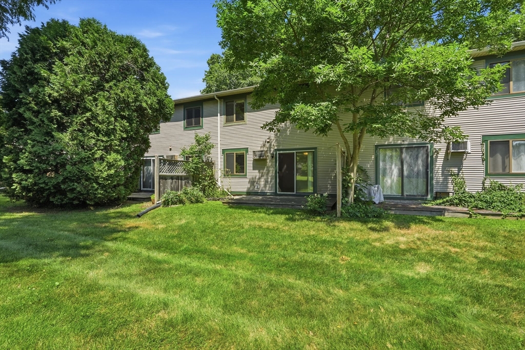 170 East Hadley Road, Unit 96 Amherst, MA 01002 - Photo 30 of 36 a front view of a house with a garden and yard