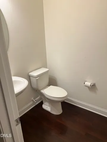 a white toilet sitting next to a white cabinet