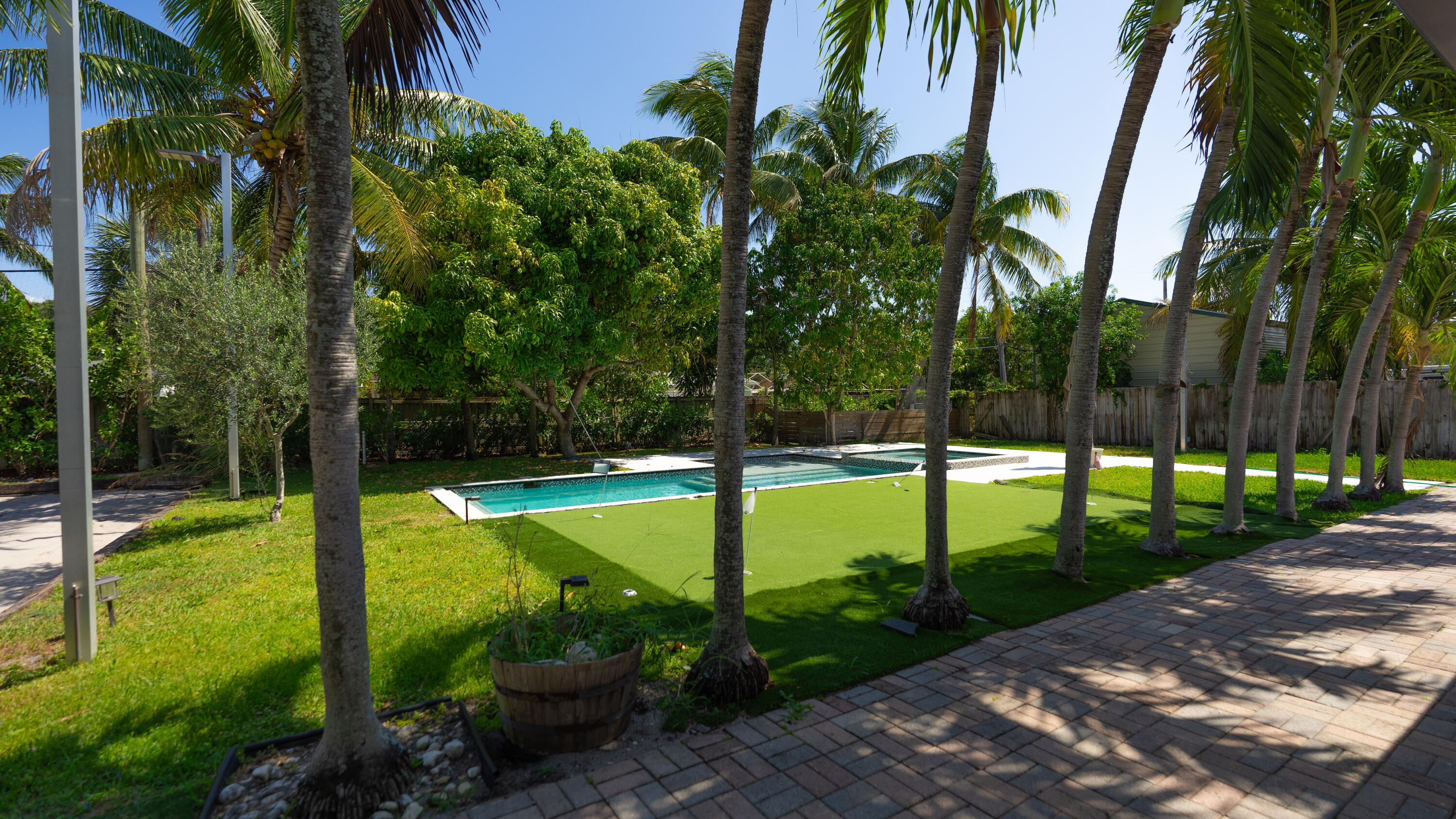 387 Enfield Street Boca Raton, FL 33487 - Photo 20 of 37 a view of a garden with tall trees