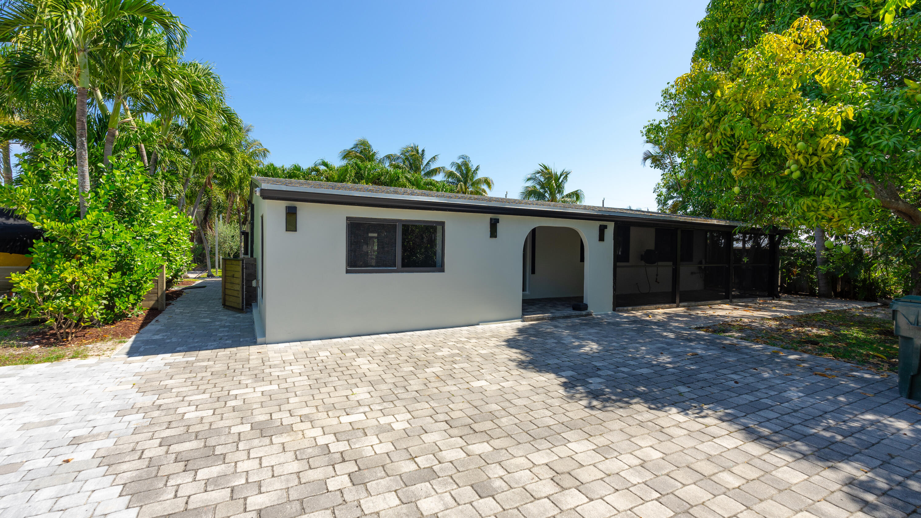 387 Enfield Street Boca Raton, FL 33487 - Photo 2 of 37 a front view of a house with a yard and trees