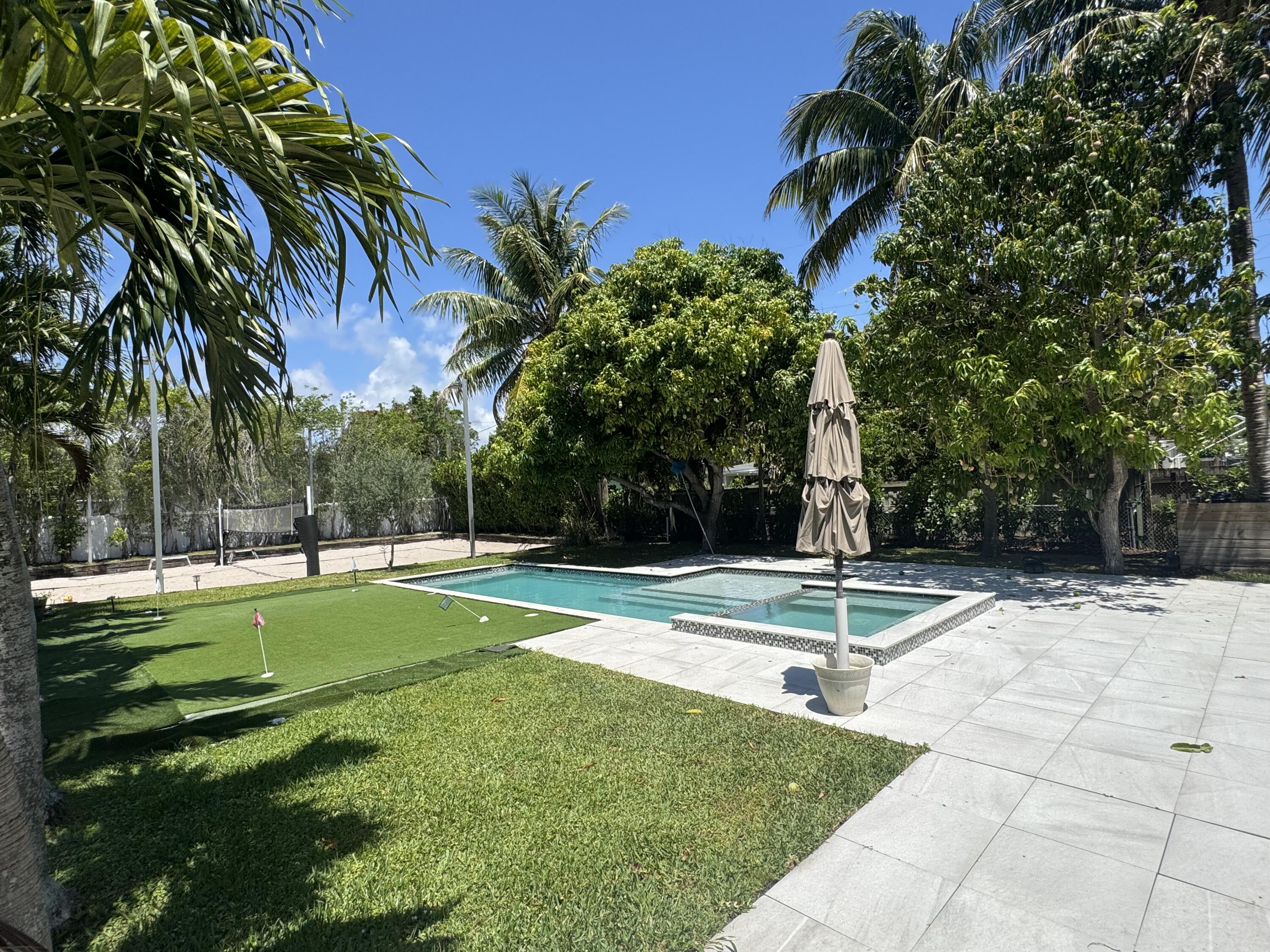 387 Enfield Street Boca Raton, FL 33487 - Photo 21 of 37 a view of a backyard with palm trees