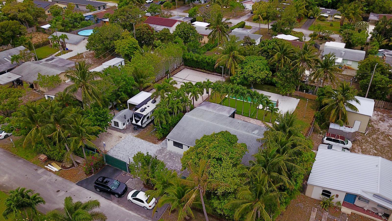 387 Enfield Street Boca Raton, FL 33487 - Photo 30 of 37 an aerial view of a house with a yard and lake view