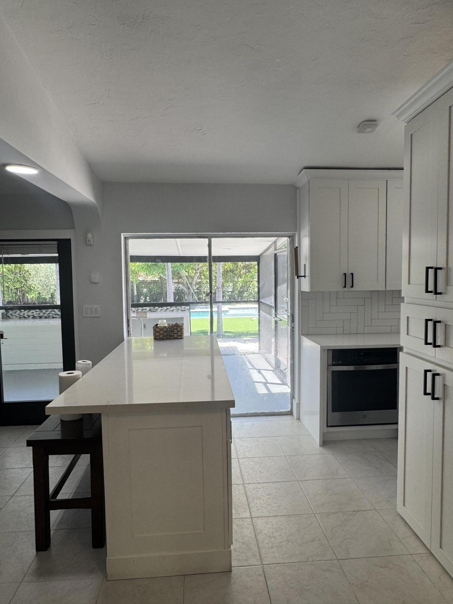 387 Enfield Street Boca Raton, FL 33487 - Photo 7 of 37 a living room with a fireplace and a table