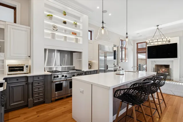 a kitchen with a stove a sink and a refrigerator
