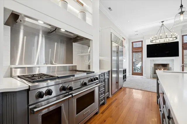 a kitchen with stove and wooden floor