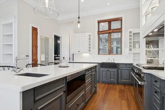 a large kitchen with stainless steel appliances granite countertop a sink stove and oven