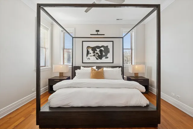 a bedroom with a bed and a painting on the wall