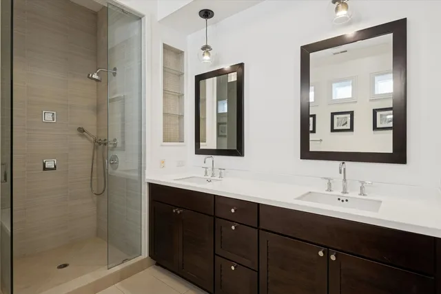 a bathroom with double sink and a mirror