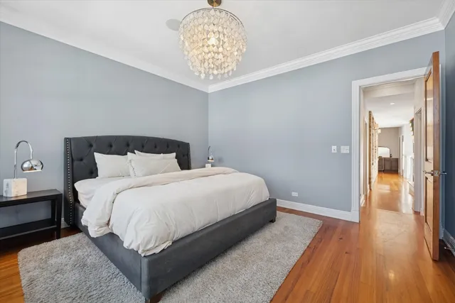 a bedroom with a bed and a chandelier