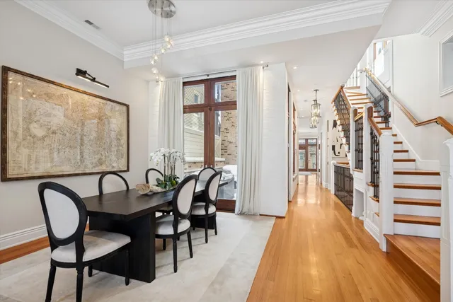 a view of a a dining room with furniture window and wooden floor