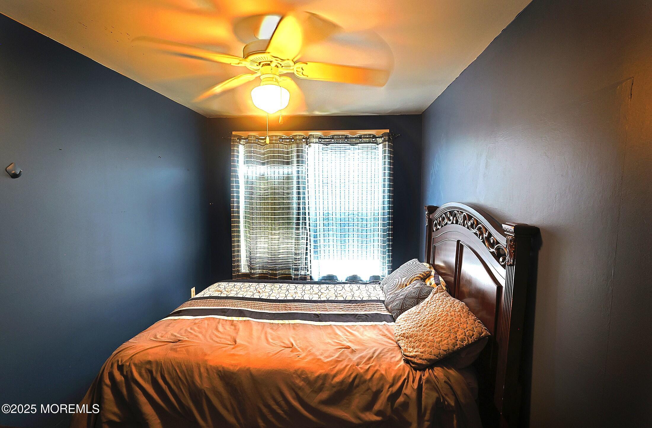1509 Embury Avenue Neptune Township, NJ 07753 - Photo 12 of 15 a bed sitting in a bedroom next to a window