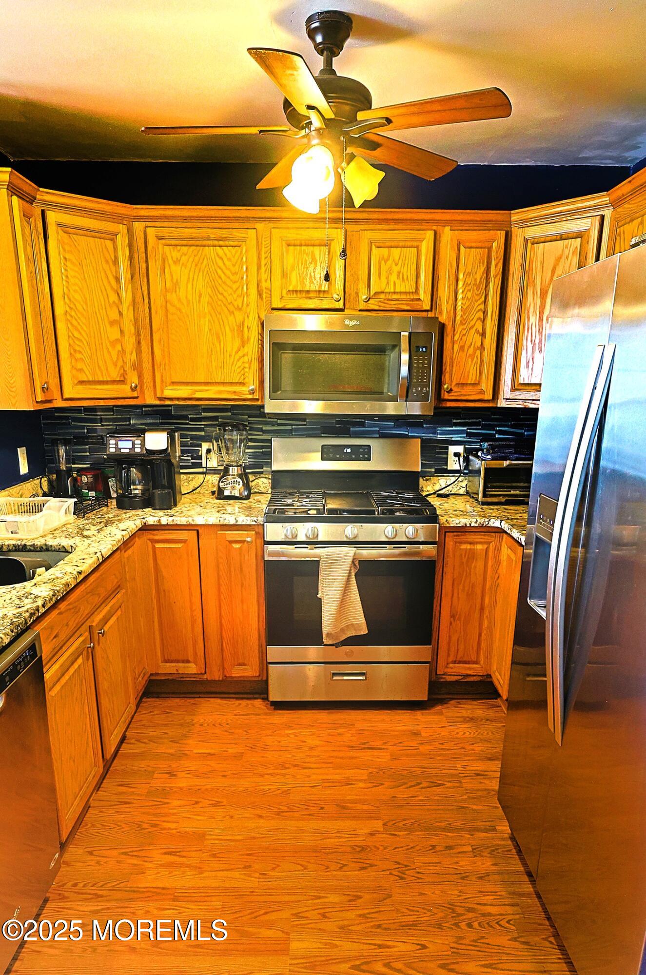 1509 Embury Avenue Neptune Township, NJ 07753 - Photo 4 of 15 a kitchen with stainless steel appliances granite countertop a stove a sink and a microwave