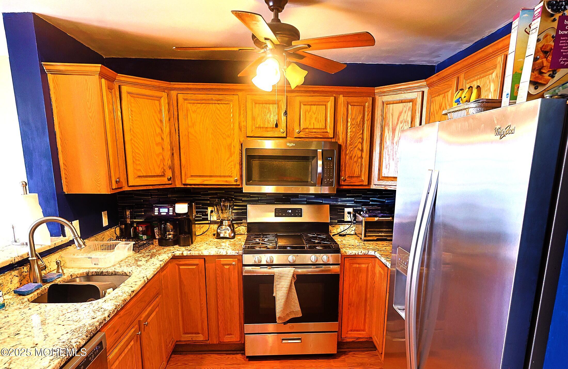 1509 Embury Avenue Neptune Township, NJ 07753 - Photo 5 of 15 a kitchen with stainless steel appliances granite countertop a stove and a sink