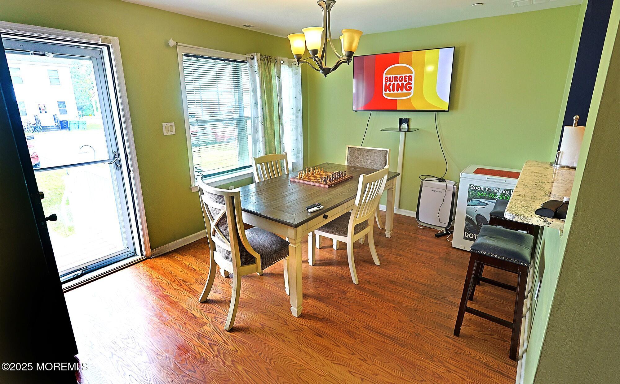 1509 Embury Avenue Neptune Township, NJ 07753 - Photo 7 of 15 a view of a dining room with furniture and wooden floor
