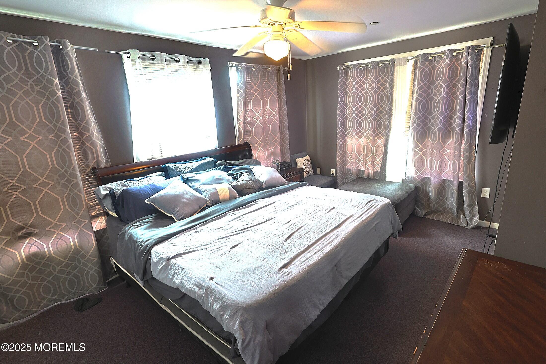 1509 Embury Avenue Neptune Township, NJ 07753 - Photo 8 of 15 a bed sitting in a bedroom next to a window