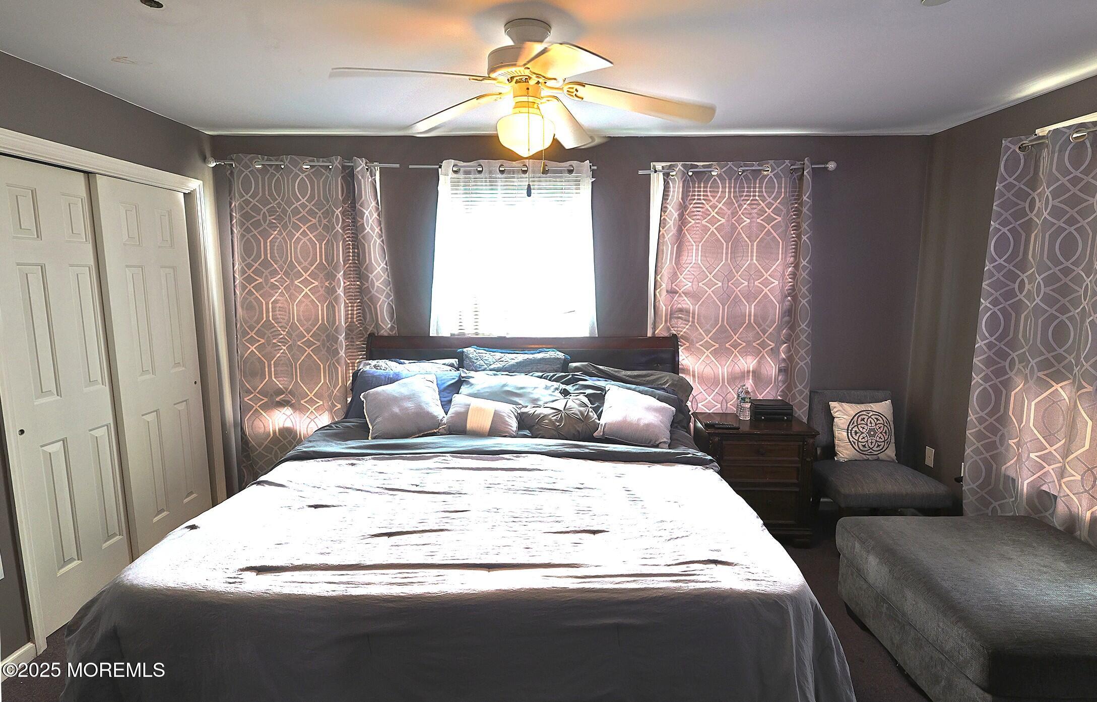 1509 Embury Avenue Neptune Township, NJ 07753 - Photo 9 of 15 a bedroom with a bed and a chandelier