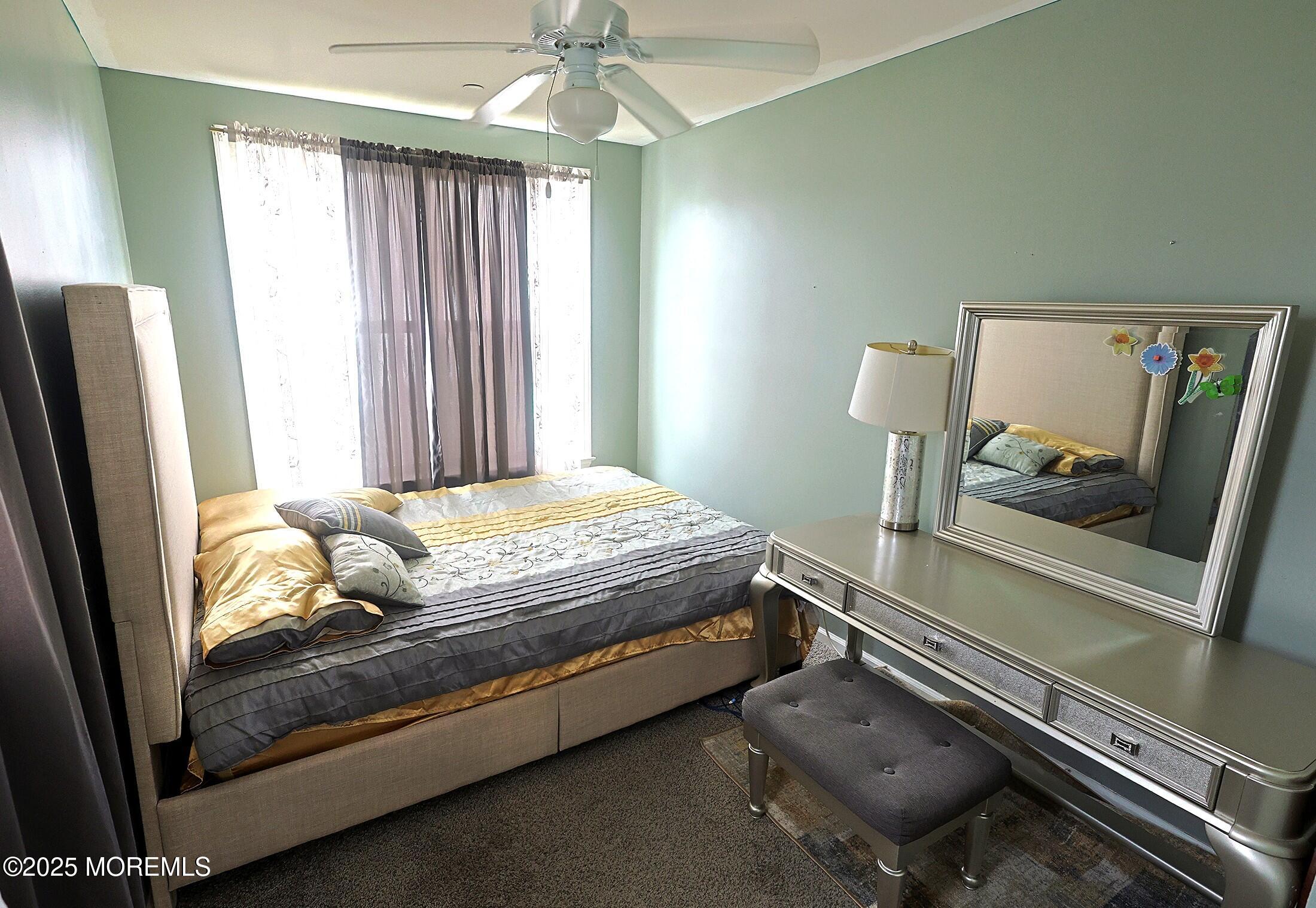 1509 Embury Avenue Neptune Township, NJ 07753 - Photo 10 of 15 a bedroom with a bed and a mirror