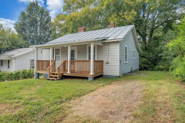 a view of a house with a yard and deck
