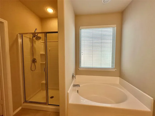 a bathroom with a bathtub and a shower